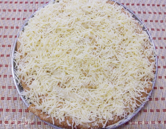 Затем посыпать пирог натертым твердым сыром.