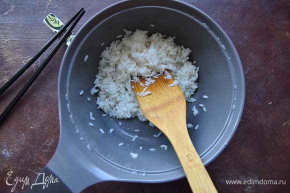 Смешать рисовый уксус, соль и сахар. Чтобы легче растворить соль и сахар, уксус можно слегка подогреть в микроволновке (10 секунд). Влить смесь в рис и деревянной лопаткой аккуратно перемешать.