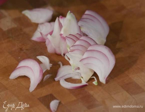 Красный лук почистить, нарезать дольками и добавить в сотейник с чесноком.