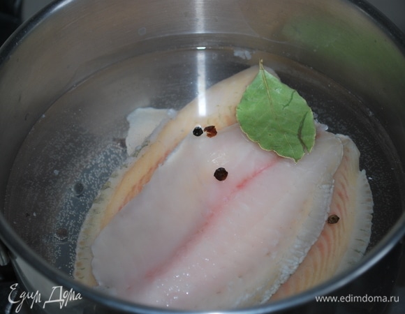 Рыбное филе положите в кастрюлю, залейте небольшим количеством воды (600 г воды), добавьте горошины черного перца и лавровый лист. Доведите до кипения.