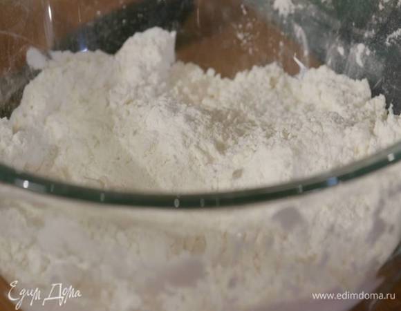В глубокой посуде перемешать 500 г муки, разрыхлитель и соль, добавить предварительно размягченное сливочное масло и растереть все руками в крошку.