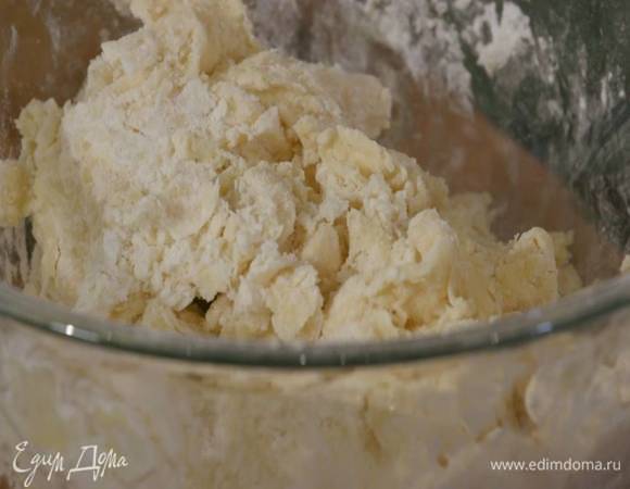 Всыпать 80 г сахарной пудры и вымесить тесто руками, затем добавить 1 ст. ложку ледяной воды и еще немного вымесить.