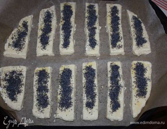 Выкладываем на пергаментную бумагу. Смажем желтком и посыпаем маком.