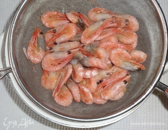 Откинуть креветки на дуршлаг.