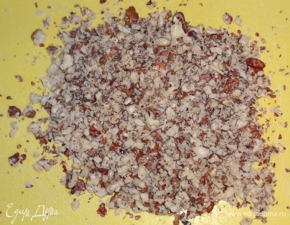 Орехи измельчить в крошку. Часть орехов добавить в миску со свеклой, перемешать.