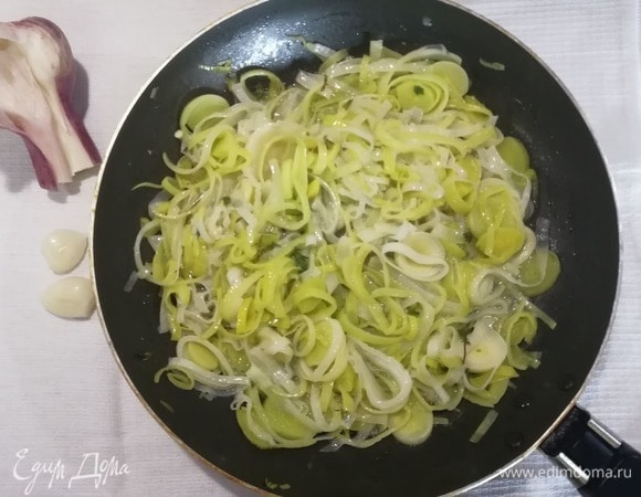 Влить в сковороду 50 мл горячей воды и тушить лук до полуготовности несколько минут.