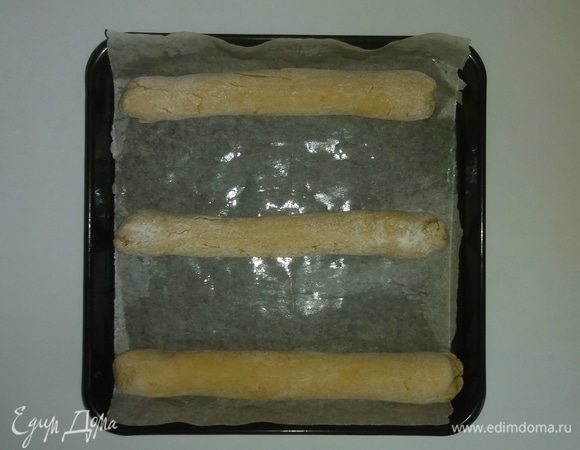 Застилаем форму бумагой для выпекания и смазываем оливковым маслом. Выкладываем колбаски из теста на расстоянии друг от друга, так как в процессе выпекания тесто может чуть-чуть расползаться. Разогреваем духовку до 200°C и ставим противень с колбасками на нижний уровень духовки на 15 минут, а затем переставляем противень с колбасками на средний уровень духовки и печем еще 10 минут (время на среднем уровне максимально может быть увеличено до 15 минут) при 200°С. Время и температура выпечки зависит от духовки. После того как первая порция испеклась, повторяем весь процесс с оставшимися колбасками.