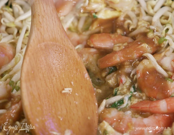 Добавить ростки сои, тамариндовую пасту, рыбный соус, выдавить немного сока лайма и перемешать.