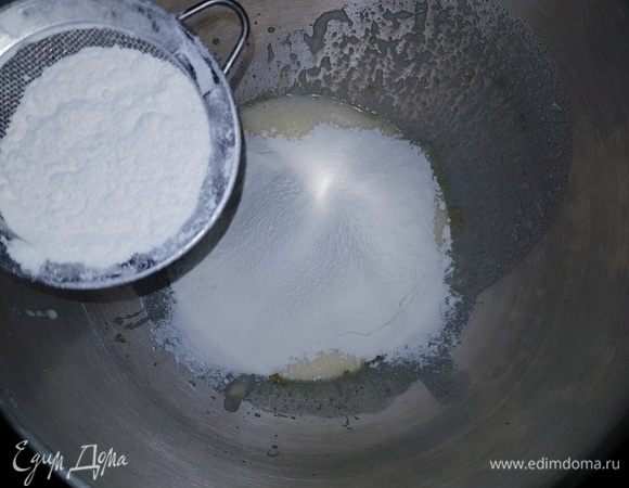 Ко взбитой яичной массе добавить опару и растопленное сливочное масло, перемешать. Сюда же просеять муку, добавить щепотку соли.