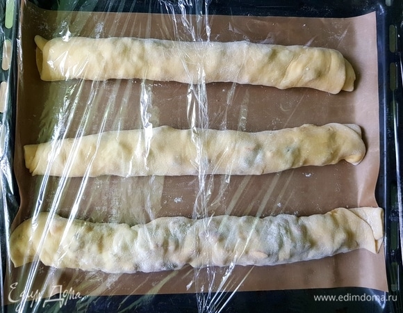 Свернуть в рулет и выложить на противень. Затянуть его пленкой и убрать в теплое место на 40 минут.