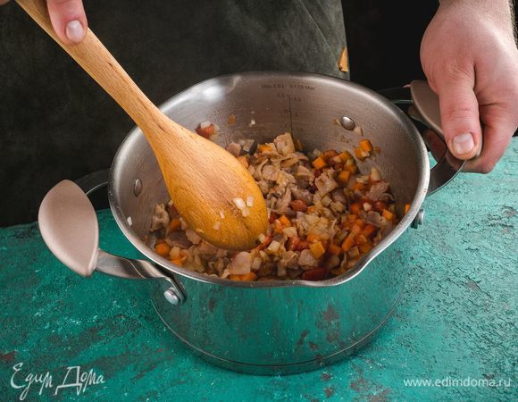 Обжарьте на растительном масле нарезанный мелко бекон в течение 2–3 минут. Добавьте к бекону нарезанные лук и морковь, затем — очищенные от кожуры и измельченные томаты. Обжарьте все вместе в течение нескольких минут.