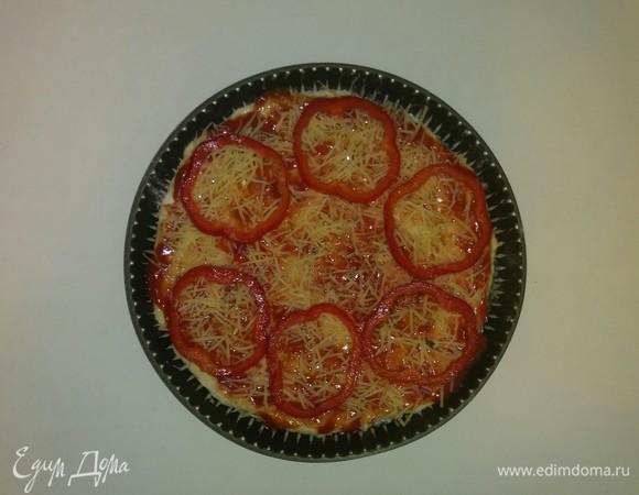 Смазываем форму для выпечки оливковым маслом, посыпаем мукой и раскатываем по форме тесто. Затем смазываем тесто протертыми помидорами, посыпаем сверху тесто сыром и раскладываем кружочки перца.