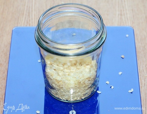 В банку насыпьте пшенные хлопья.