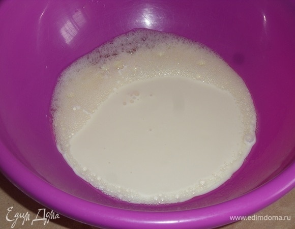 Затем добавляем ряженку. Перемешиваем массу.