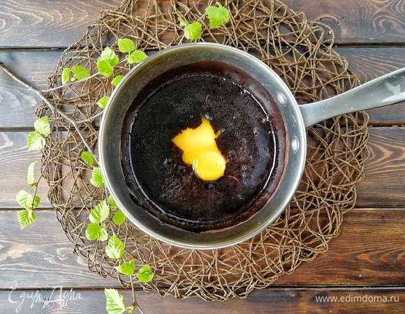 Желтки вливаем в остывшую примерно до 40°С смесь с какао и хорошо перемешиваем.