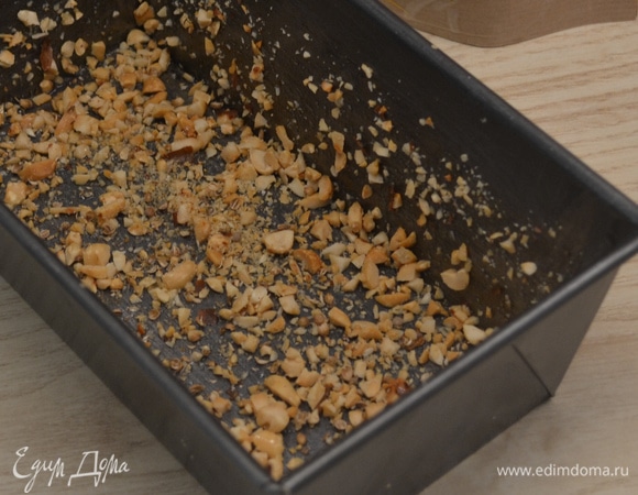 Арахис мелко порубить. Форму смазать маслом и обильно посыпать арахисом.
