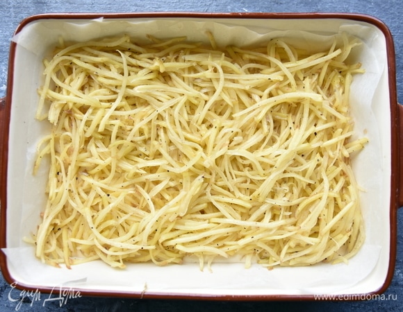 Сверху на тесте распределить сырой натертый картофель.