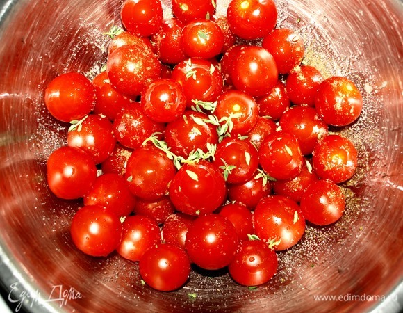 Подготовленные помидоры черри складываем в миску. Добавляем соль, перец, листики 1 веточки свежего тимьяна, растительное масло. Аккуратно перемешиваем.