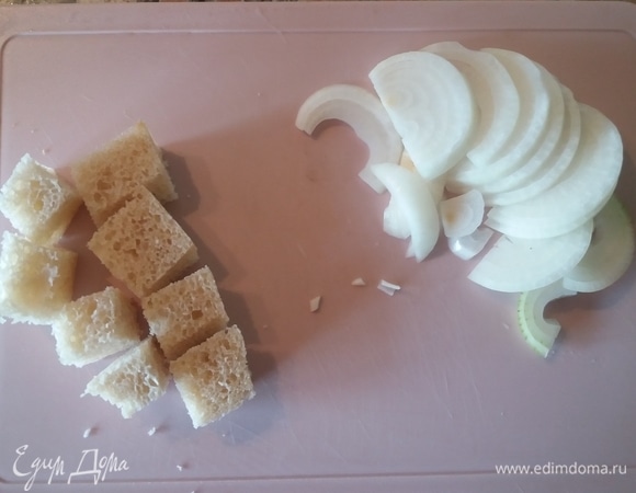 Нарезать лук полукольцами, хлеб — кубиками.