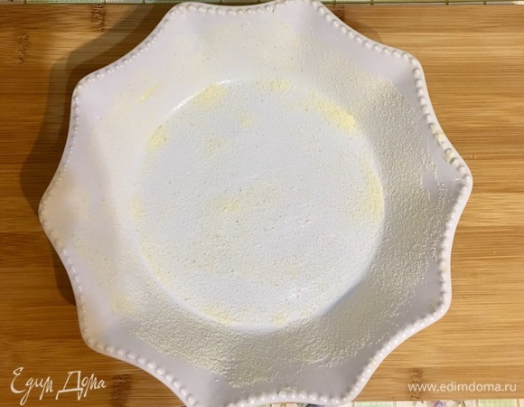 Форму для запекания диаметром 20 см смазываем сливочным маслом и сверху посыпаем манной крупой так, чтобы форма вся была посыпана.