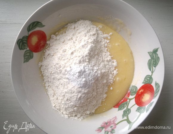 Порциями всыпать просеянную муку и разрыхлитель и перемешать.