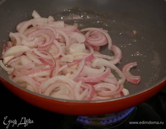 Разогреть в маленькой сковороде 1‒2 ст. ложки оливкового масла и обжарить лук и чеснок.