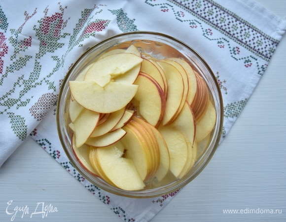 Яблоки разрезать пополам, освободить от сердцевины и нарезать тонкими ломтиками. Залить кипятком, чтобы ломтики стали более эластичными.