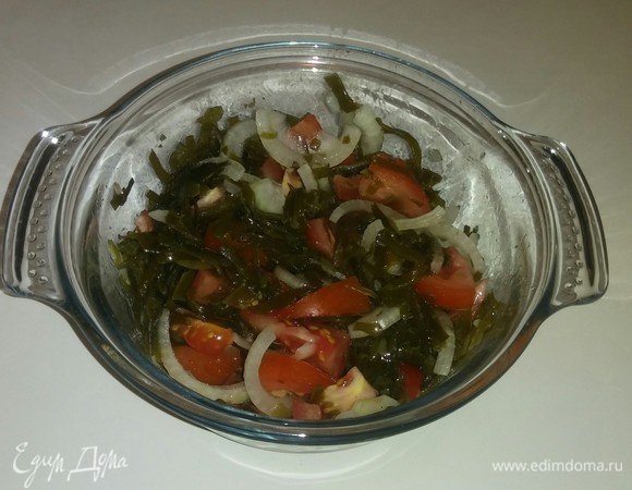 В емкость к морской капусте добавляем нарезанные помидоры и репчатый лук, соль, перец и оливковое масло. Все перемешиваем и охлаждаем около 10 минут в холодильнике. Салат готов. Приятного аппетита!