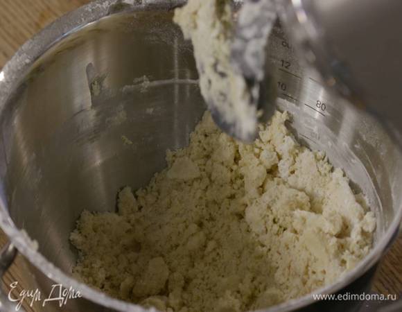 В чаше комбайна соединить предварительно размягченное сливочное масло, тростниковый сахар, 15 г ванильного сахара и все взбить. Не выключая комбайна, всыпать часть муки, добавить соль и яичные желтки, затем всыпать оставшуюся муку и вымешать еще немного — должна получиться крошка.