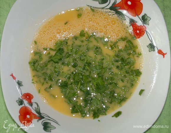 В миске взболтать яйца и добавить мелко нарезанную зелень петрушки.