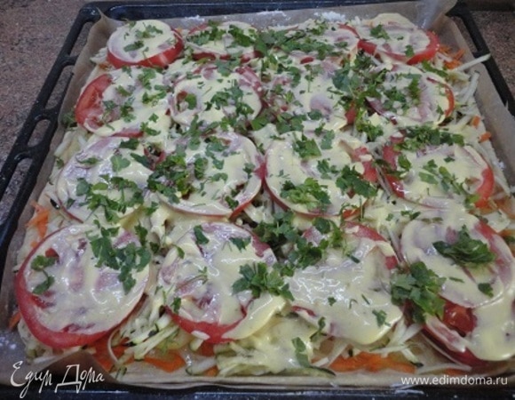 Начинку выложить в следующем порядке: половина сыра, морковь, лук, перец, кабачки, чеснок, помидоры. Между слоями солить и перчить по вкусу. Смазать майонезом и посыпать зеленью. Выпекать 25–30 минут. За 10 минут до готовности посыпать пиццу оставшимся сыром и продолжить запекать.