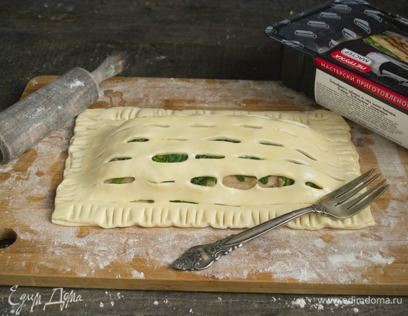 Разбиваем яйцо в миску, смешиваем вилкой. Смазываем края яйцом, накрываем перфорированным листом теста, прижимаем вилкой, снова смазываем яйцом весь пирожок.