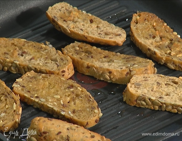Сковороду-гриль сбрызнуть оливковым маслом. Хлеб нарезать толстыми ломтиками, обжарить с двух сторон.