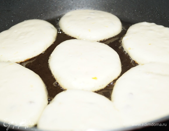 Разогрейте сковороду с растительным маслом и столовой ложкой выложите тесто в кипящее масло. Чем больше масла, тем румяней оладьи. Масло должно скрывать дно сковороды.