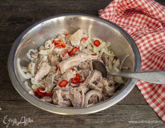 Стручок красного чили режем колечками. К мясу добавляем маринованный лук и нарезанный чили.