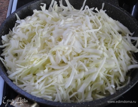 Лук нарезать мелкими кубиками и поджарить в растительном масле до золотистого цвета. Капусту нашинковать, выложить к луку и тушить на медленном огне под крышкой 10 минут.