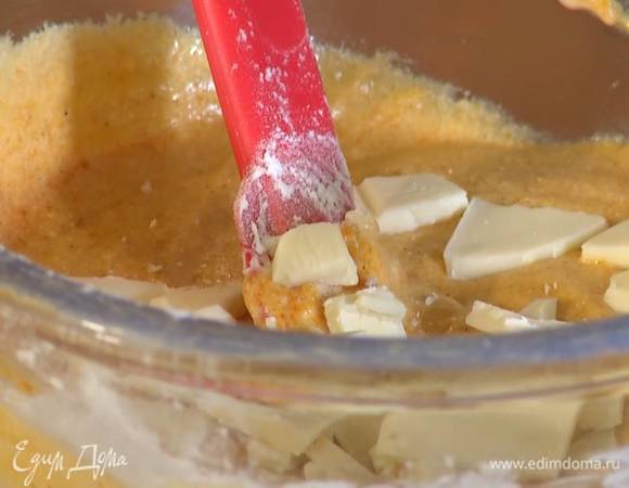 Поломать небольшими кусочками 100 г белого шоколада, добавить в тесто и перемешать.