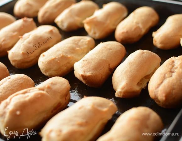 Духовку разогреть до 270°C. Поставить противень в предварительно разогретую духовку и выпекать 30 минут при температуре 180–200°C в зависимости от мощности духовки. Важно, чтобы сначала была очень высокая температура. Это даст возможность нашим эклерчикам хорошо подняться и зарумяниться. А потом нужна умеренная температура, чтобы эклеры закрепили свою форму и не опали после того, как вы их достанете из духовки. У меня духовка печет слабо, поэтому я пекла так: поставила противень в разогретую до 270°C духовку и пекла при этой температуре 4 минуты. Затем убавили газ до 200°C и пекла еще 26 минут. Эклеры отлично поднялись и равномерно зарумянились. Как раз то, что нужно.
