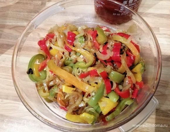 Перцы (желательно разных цветов) нарезать на полоски, две крупные луковицы нарезать полукольцами. Обжарить овощи на растительном масле до мягкости.
