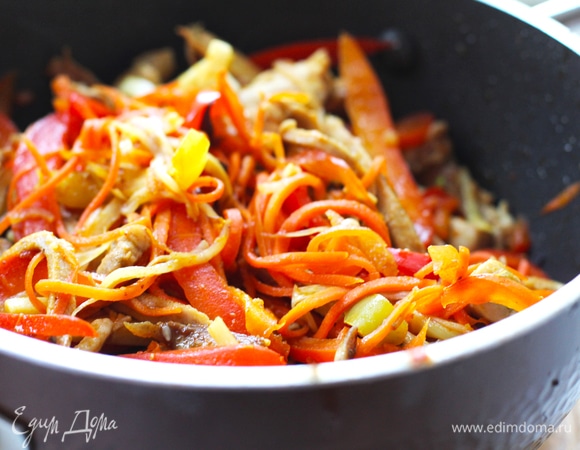 В сковороду добавить немного масла, забросить имбирь, чеснок и сладкий перец (и острый, если используется). Готовим на большом огне 2–3 минуты. Основной критерий — сладкий перец должен хрустеть, не должен потерять свет и стать мягким. Добавить в сковороду корейскую морковь, мясо и влить соус. Готовить на среднем огне меньше минуты и влить крахмальную воду. Соус должен закипеть. Выключить огонь. Попробуйте на соль, корейская морковь дает много вкуса, старайтесь не переборщить с солью.