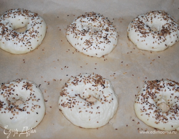 Выложите их на пекарскую бумагу, посыпьте кунжутом. Выпекайте при температуре 180°C 25–30 минут до готовности.