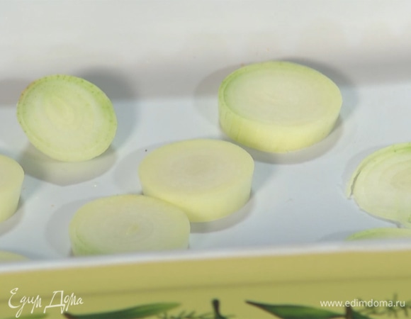 Нарезать лук толстыми кольцами и выложить на дно формы для запекания.