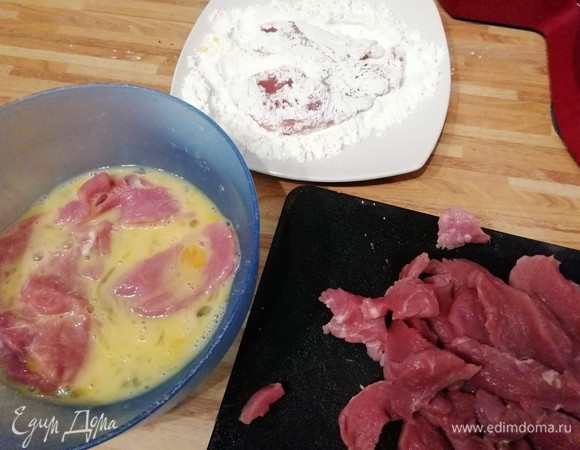 Филе промыть, обсушить и нарезать кусочки мяса тонкими ломтиками, слегка посолить и протянуть кусочки через взбитые яйца. Положить в миску, посыпать крахмалом и хорошо перемешать. Они должны быть равномерно покрыты крахмалом. Кусочки лучше всего разложить на большой тарелке рядом друг с другом, чтобы потом их можно было хорошо обжарить порциями.
