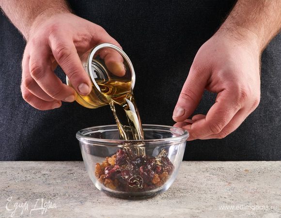 Клюкву и изюм залейте горячим ромом и оставьте на 20 минут.