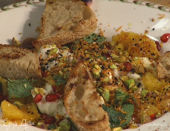 Выложить апельсины, сверху посыпать заправкой с фисташками. Полить оливковым маслом, дополнить хлебом.  