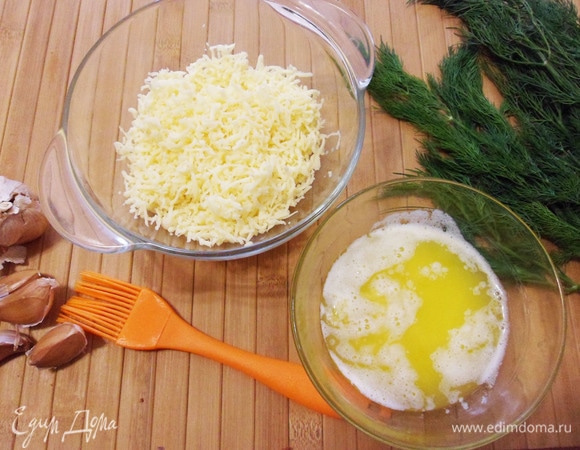 Чеснок измельчаем и смешиваем с растопленным сливочным маслом. Сыр натираем на терке.