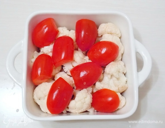 Помидорки вымоем и разрежем пополам. Уложим черри поверх капусты.
