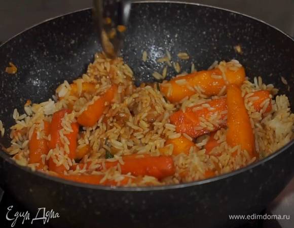Бланшированную морковь переложить шумовкой в вок с овощами, влить соевый соус, кленовый сироп, все перемешать, добавить рис и помешивая, обжаривать несколько минут, затем снять с огня.