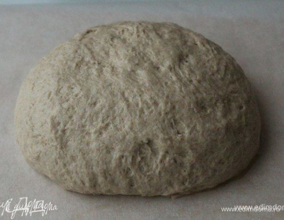 Сформовать из теста шар, переложить в миску, накрыть полотенцем и оставить на 1 час. Затем тесто аккуратно обмять, снова сформовать шар и оставить еще на 45 минут на второй подъем.