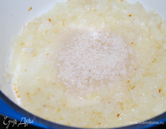 Лук нарежьте и обжарьте в казане на растительном масле вместе с горсткой риса до легкого золотистого цвета.